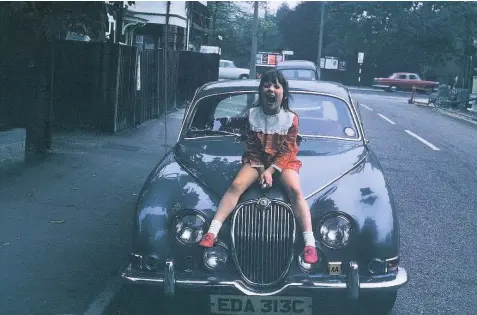  ??  ?? Alison sitting on the bonnet of her grandparen­ts’ Jaguar in 1965
