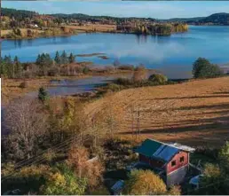  ??  ?? Det lille, røde tømmerhuse­t ligger rett nord for enden av innsjøen Råsen i Nord-Odal.