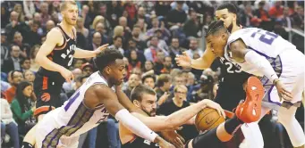  ?? DAN HAMILTON/USA TODAY SPORTS ?? Raptors centre Marc Gasol battles for the ball with Sacramento Kings Buddy Hield, left, and Richaun Holmes during a hard-fought game at Toronto’s Scotiabank Arena Wednesday night.