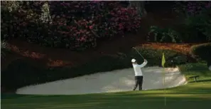  ?? The Associated Press ?? ■ Rory McIlroy, of Northern Ireland, hits from the bunker on the 13th hole during Tuesday’s practice round for the Masters in Augusta, Ga.