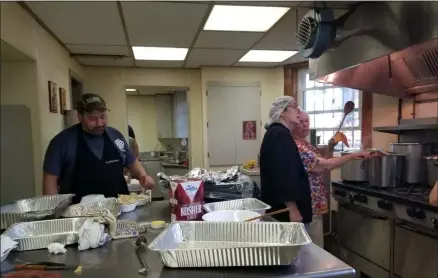  ?? JORDANA JOY — THE MORNING JOURNAL ?? Members of SS Peter and Paul Orthodox Church, 2238 E. 32nd St. in Lorain, are hard at work preparing and sending out food during the church’s annual Russian Food Festival Aug. 16.