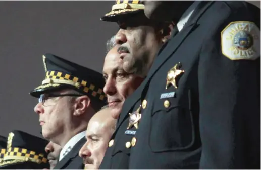  ?? SUN- TIMES FILE PHOTO ?? Mayor Rahm Emanuel and Police Supt. Eddie Johnson at a Police Academy graduation last year. More than a year into the Chicago Police Department’s biggest hiring surge in decades, 14 of the city’s 22 police districts actually have fewer beat cops than...