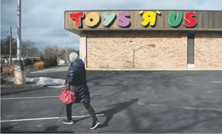  ?? Julio Cortez, The Associated Press ?? A woman walks in a parking lot of a Toys R Us store in January in Wayne, N.J. Toys R Us, squeezed by Amazon.com and huge chains like Walmart, will close its 800 stores in the United States, including seven in Colorado.