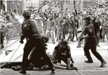  ?? Ken Lambert / Associated Press ?? A federal judge late Friday ordered Seattle to temporaril­y stop using tear gas, pepper spray and flash bang devices on protests.