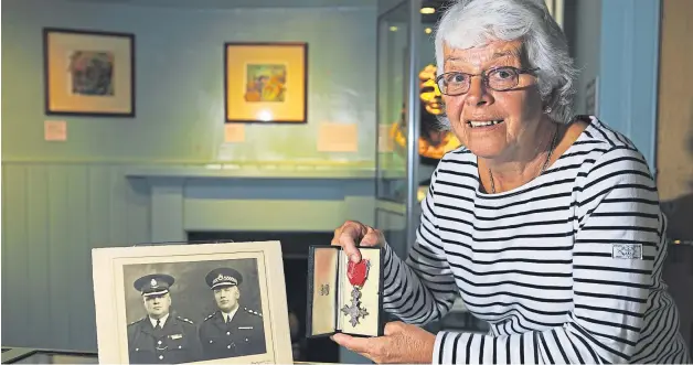  ?? Irene Wright at the Gateway to the Glens Museum with an MBE and photo of David and James Storrier, along with other objects that she donated. Picture: Dougie Nicolson. ??