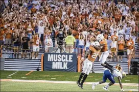  ?? RICARDO B. BRAZZIELL / AMERICAN-STATESMAN ?? Longhorns defensive back B.J. Foster (25) celebrates an intercepti­on against Tulsa on Saturday. Texas won, but the perception is the team didn’t take a real step forward.