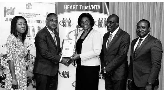  ??  ?? From left: Loy Malcolm, general manager of technical services, JSIF; Omar Sweeney, managing director, JSIF; Dr Janet Dyer, managing director, HEART Trust/NTA; Ruel Reid, minister of education, youth and informatio­n; and Edward Gabbidon, chairman, HEART Trust/NTA, after the MOU signing at the JSIF head office on Thursday, March 7.