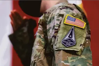  ?? Noah Berger / San Francisco Chronicle ?? A Space Force member salutes during a ceremony at Travis Air Force Base in Solano County last year for Air Force airmen transition­ing to the military’s newest agency (founded in 2018).