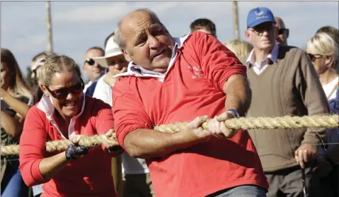  ??  ?? Mandy Galligan and Ali Carstairs pulling for Byrne and Woods in the Tug of War competitio­n at the Roundwood Festival.