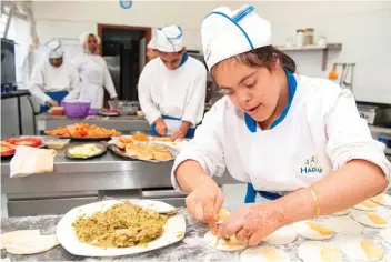  ??  ?? A woman suffering from mental illness works in a restaurant of Morocco’s Hadaf associatio­n on Sept. 26 in Rabat. (AFP)