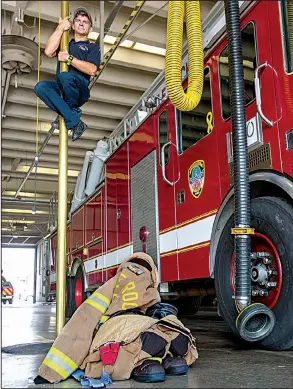  ?? Arkansas Democrat-Gazette/BENJAMIN KRAIN ?? Little Rock firefighte­r Jeffrey Grove slides down a fire pole Thursday at Central Station to board the truck with other firemen responding to an emergency call. The Little Rock Fire Department announced Thursday that it received Accredited Agency...