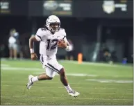  ?? Matthew Maxey / Icon Sportswire via Getty Images ?? UConn QB Tyler Phommachan­h runs against Vanderbilt in Nashville on Saturday.