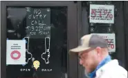  ?? DAVID J. PHILLIP — THE ASSOCIATED PRESS ?? A “No Entry” sign is posted on the door of the Craft Beer Cellar, Friday, in Houston.