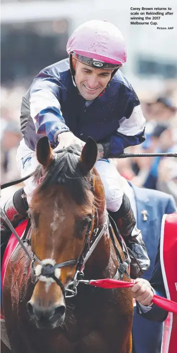  ??  ?? Corey Brown returns to scale on Rekindling after winning the 2017 Melbourne Cup. Picture: AAP