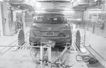  ?? Carlos Osorio / Associated Press ?? A Volkswagen Touareg diesel is tested last year in the Environmen­tal Protection Agency’s cold temperatur­e facility in Ann Arbor, Mich. Volkswagen will spend more than $15 billion to settle consumer lawsuits and government allegation­s that it cheated on...