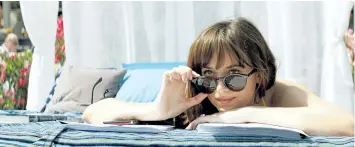  ?? MOVIE STILLS ?? Dakota Johnson, above, and Jamie Dornan worked with sex toy experts on the Fifty Shades films, so they would look like they would know what they were doing during steamy scenes.