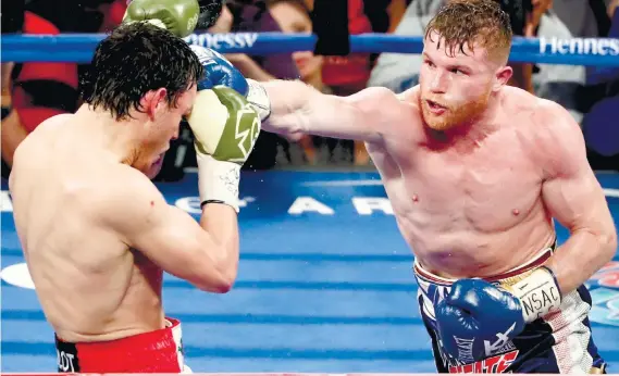  ?? AP FOTO ?? TAKING CONTROL. Saul ‘Canelo’ Alvarez (right) punishes Julio Cesar Chavez Jr. and controls the match from start to finish.