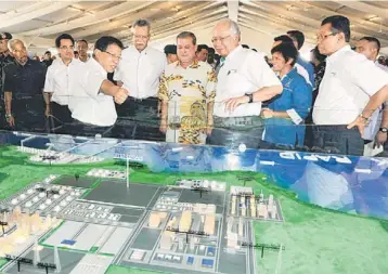  ??  ?? SECOND LARGEST INVESTMENT: File photo shows Najib looking at a model of the Rapid project during the launch last year. The speculated RM25 billion investment would be the second largest in PIPC after Petronas committed to investing RM60 billion for the...