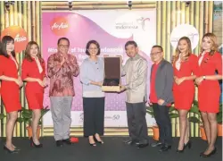  ??  ?? Waloni (third from left), Aireen, Rifajantor­o and Taberi flanked by AirAsia cabin crew at the official launch of the partnershi­p between the Indonesian Ministry of Tourism and AirAsia yesterday.