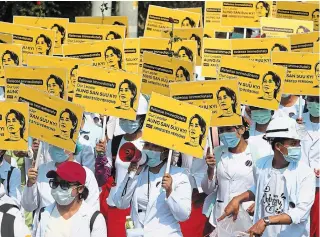  ?? THE ASSOCIATED PRESS ?? Medicals students display images of deposed Myanmar leader Aung San Suu Kyi during a street march in the country’s second-largest city of Mandalay on Friday.