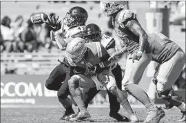  ?? Robert Gauthier Los Angeles Times ?? DORIAN THOMPSON-ROBINSON, middle, loses the football against San Diego State in September. Thompson-Robinson has lost five fumbles this season.