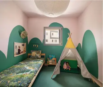  ?? (Yoav Peled/Peled Studios) (Courtesy Sura Shachnovit­z) ?? A GIRL’S bedroom becomes a magical wonderland designed with two points of inspiratio­n: fairytale vintage sheets, and the rolling hills hand-painted mural of Modi’in, bringing curvature to boxy space. Designer: Daniella Jaeger. (BELOW) A steel door doesn’t have to be unsightly: A mural makes the mamad pretty inside and out, with storage and beverages organized neatly on the inside. Designer: Sura Shachnovit­z | Respace.