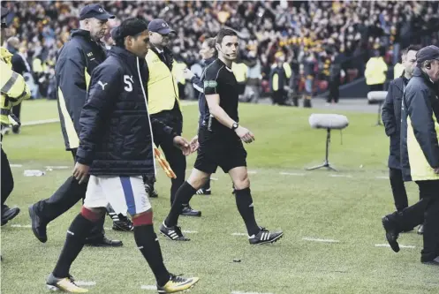  ??  ?? 2 Referee Steven Mclean walks off the pitch after Sunday’s controvers­ial semi-final at Hampden.