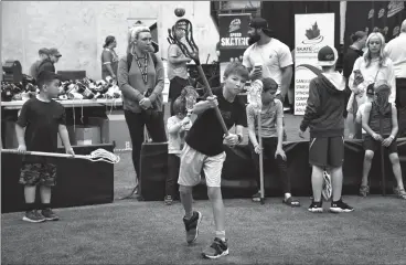  ?? HERALD PHOTOS BY JUSTIN SEWARD ?? Bryson Shields fires the lacrosse ball during SportFest at Servus Sports Centre on Saturday. Below: Noah Haynes practices his punches with Lethbridge Boxing Club’s Rick Duff.