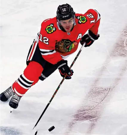  ?? CHRIS SWEDA/CHICAGO TRIBUNE ?? Blackhawks left wing Alex DeBrincat skates with the puck in the second period of a game against the Hurricanes on Tuesday at the United Center.