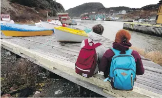  ??  ?? French tourists Mathilde Gufflet, left, and Eleonore Scholler explore Quidi Vidi Village.