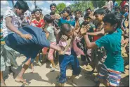  ?? AP/DAR YASIN ?? Rohingya Muslims, who recently crossed from Burma into Bangladesh, beat a man suspected of being a child trafficker Friday near a Balukhali refugee camp.