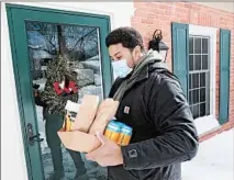  ?? JOHN J. KIM/CHICAGO TRIBUNE ?? Dovetail Brewery driver Luis Matos checks the order list for a residence on Thursday in Glenview. Matos has delivered beer and merchandis­e for the craft brewery since last summer.