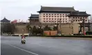  ?? Photograph: Xinhua/REX/Shuttersto­ck ?? A delivery rider on an empty street near Yongning gate in Xi’an, which has been under lockdown for six days.