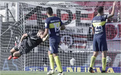  ??  ?? BUENOS AIRES: Boca Junior’s goalkeeper Axel Werner (L) fails to stop River Plate’s forward Lucas Alario’s (not in frame) ball during their Argentina First Division football match at El Monumental stadium, in Buenos Aires, on Sunday. —AFP