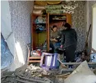  ?? AP ?? Women in their apartment after a Russian air strike in Bakhmut.