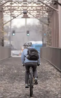  ?? Joe Jaszewski /The Washington Post ?? A cyclist pedals over a former railroad bridge along the 25mile Boise River Greenbelt trail in Boise.