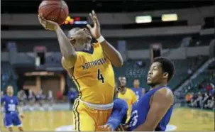  ?? JOHN BLAINE — FOR THE TRENTONIAN ?? Nottingham’s Cliff Joseph (4) goes up for a shot over Ewing’s Kameron Clark (23) during a semifinal MCT game at CURE Insurance Arena on Tuesday night.