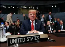  ??  ?? U.S. President Donald Trump takes his seat as he attends the multilater­al meeting of the North Atlantic Council, on Wednesday, in Brussels, Belgium.
AP PhoTo/PAblo MArTInez MonsIVAIs/Pool