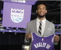  ?? MIKE BUSH/ NEWS SENTINEL ?? New Sacramento Kings forward Marvin Bagley III holds his new jersey at the Golden 1 Center on Saturday.