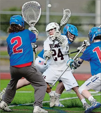  ?? SARAH GORDON/THE DAY ?? East Lyme’s Connor Schofner (24) attempts a shot on Waterford goalie Cooper Alloway (2) during Thursday’s ECC boys’ lacrosse tournament final at East Lyme. The Vikings won their eighth straight title by holding off the Lancers 13-12. Visit...