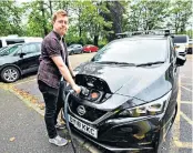  ??  ?? TAKING CHARGE Jack recharges the Leaf’s battery; concerns remain about the number of charging points