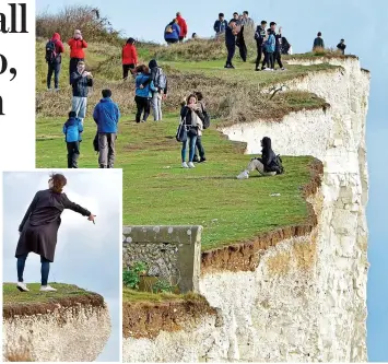  ??  ?? Peril: Tourists taking photos at Birling Gap and, left, a woman leans over the edge