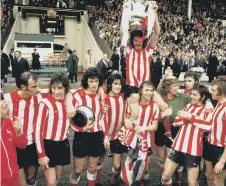  ??  ?? Captain Bobby Kerr held aloft by Billy Hughes and Jim Montgomery.