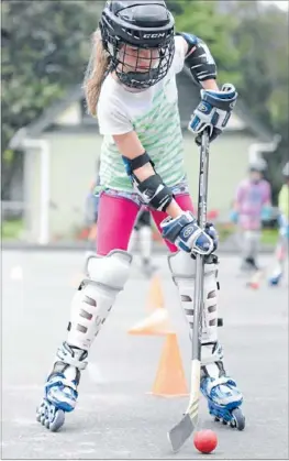  ??  ?? Stick with it: Tawa School pupil Sammy Park, 10, got the hang of skating while driving a puck at an inline hockey camp last Wednesday.