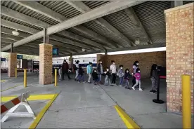  ?? JULIO CORTEZ — THE ASSOCIATED PRESS ?? Migrants are released from U.S. Customs and Border Protection custody at a bus station Wednesday in Brownsvill­e, Texas. The surge of migrants on the Southwest border has the Biden administra­tion on the defensive.