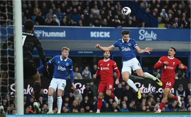  ?? — AFP ?? LIVERPOOL: Everton’s English defender #06 James Tarkowski heads at goal during the English Premier League football match between Everton and Liverpool at Goodison Park in Liverpool, north west England.