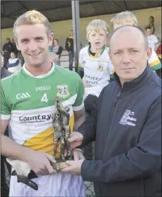  ??  ?? Stefan Potts receives the man-of-the-match award from Mark Kirwan of CTI Business Solutions.