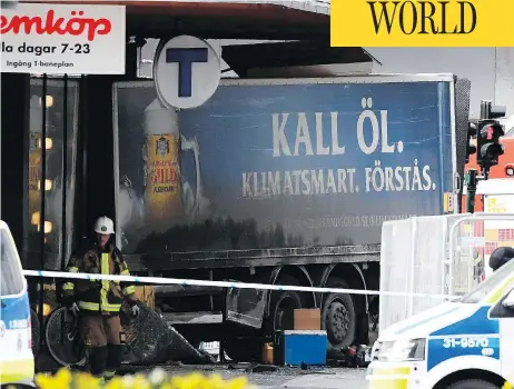  ?? JONATHAN NACKSTRAND / AFP / GETTY IMAGES ?? A truck driver killed four pedestrian­s and injured 15 before ramming the vehicle into a department store in downtown Stockholm on Friday.