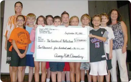  ??  ?? Student Council leaders present a giant check to Ellen Saracini, far right, to help for the upkeep of the Garden of Reflection in Lower Makefield Township. Dr. Peggy Schiavone is pictured far left.(Photo by Petra Chesner Schlatter)