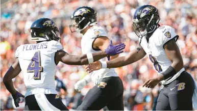  ?? SUE OGROCKI/AP ?? Ravens quarterbac­k Lamar Jackson, right, celebrates with wide receiver Zay Flowers, left, after running for a 10-yard touchdown in the first half Sunday against the Browns in Cleveland.